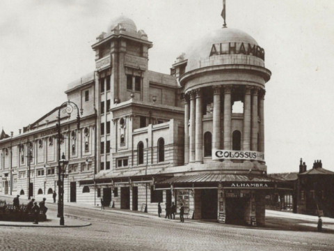 Black and white photograph of the outside of the Alhambra Theatre from Great Horton Road shows the domes and columns of the old foyer.